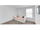 Bright bedroom featuring a bed with storage drawers, neutral carpet, and a window with natural light at 9717 Chuckwalla Pl, Fishers, IN 46040
