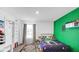 This bedroom is equipped with playful decor, a window, and painted accent walls for a fun space at 9717 Chuckwalla Pl, Fishers, IN 46040