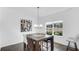 Bright dining room featuring wood floors, modern table with seating for six, and a large window at 9717 Chuckwalla Pl, Fishers, IN 46040