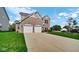 Beautiful two-story brick home with a spacious driveway and well-manicured lawn at 9717 Chuckwalla Pl, Fishers, IN 46040