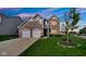 Charming two-story brick home featuring a two-car garage and beautifully landscaped front yard at 9717 Chuckwalla Pl, Fishers, IN 46040