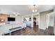 Open-concept living room with hardwood floors, modern decor, and seamless flow to dining and kitchen areas at 9717 Chuckwalla Pl, Fishers, IN 46040