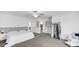 Spacious main bedroom with neutral decor, ceiling fan, plush carpet, and ample closet space for storage at 9717 Chuckwalla Pl, Fishers, IN 46040