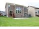 Spacious backyard with lush lawn, wooden deck, and a concrete patio at 9903 Deep Royal Way, Indianapolis, IN 46239