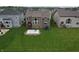 Aerial view of a large backyard featuring a patio, lawn and residential homes at 9903 Deep Royal Way, Indianapolis, IN 46239