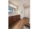 Double sink vanity with matching towels, hardwood floors, and white door at 9903 Deep Royal Way, Indianapolis, IN 46239