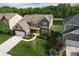 Aerial view of a two-story home with manicured lawn and an attached garage at 9903 Deep Royal Way, Indianapolis, IN 46239