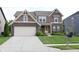 Charming two-story home featuring brick and siding, a two-car garage, and a well-manicured lawn at 9903 Deep Royal Way, Indianapolis, IN 46239