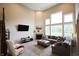 Spacious living room with high ceilings, a cozy fireplace, and abundant natural light, perfect for relaxation at 9903 Deep Royal Way, Indianapolis, IN 46239