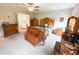 Comfortable main bedroom with hardwood furniture, including bed, dressers, and vanity at 9903 Deep Royal Way, Indianapolis, IN 46239