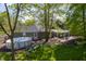 Backyard with above ground pool, patio with pergola, chairs and lush green grass at 1052 Barley Cir, Carmel, IN 46032