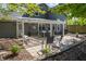 Backyard patio featuring a pergola with patio furniture and wooded views at 1052 Barley Cir, Carmel, IN 46032
