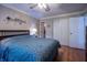 This bedroom features a spacious closet, wood laminate flooring, and neutral color walls at 1052 Barley Cir, Carmel, IN 46032