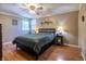 Comfortable bedroom with natural light from windows and stylish ceiling fan and wood laminate flooring at 1052 Barley Cir, Carmel, IN 46032
