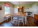 Charming dining room with a wooden table set, a window bench, and hardwood flooring at 1052 Barley Cir, Carmel, IN 46032