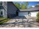 Spacious three car garage with driveway and exterior bench with flower pots for landscaping at 1052 Barley Cir, Carmel, IN 46032