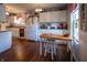 Well-lit kitchen featuring white cabinetry, modern appliances, and wooden floors at 1052 Barley Cir, Carmel, IN 46032