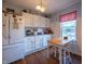 Bright kitchen featuring white cabinetry, laminate countertops, and stainless-steel appliances with dining nook at 1052 Barley Cir, Carmel, IN 46032