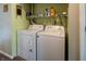 Laundry area with washer, dryer, overhead shelf, and green walls at 1052 Barley Cir, Carmel, IN 46032