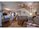 Bright and inviting living room featuring hardwood floors, a wooden staircase, and ample natural light at 1052 Barley Cir, Carmel, IN 46032