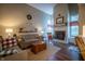 Cozy living room with fireplace, wood floors, a comfortable sofa, and plenty of natural light at 1052 Barley Cir, Carmel, IN 46032