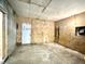 Unfinished basement with bare plywood walls, concrete floor, and door frame at 106 S Hancock St, Waynetown, IN 47990