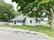 Charming single-story home with a well-maintained lawn and lush greenery, perfect for comfortable living at 106 S Hancock St, Waynetown, IN 47990