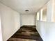 Bright hallway featuring hardwood-look vinyl plank floors and traditional wood paneling at 106 S Hancock St, Waynetown, IN 47990
