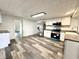 Bright kitchen with stainless steel appliances, white cabinets, and vinyl floors, offering both style and functionality at 106 S Hancock St, Waynetown, IN 47990
