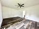Spacious living room featuring modern ceiling fan and rich wood-look vinyl plank flooring at 106 S Hancock St, Waynetown, IN 47990