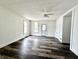 Bright, airy living room with fresh paint, modern ceiling fan, and vinyl flooring, creating a cozy gathering space at 106 S Hancock St, Waynetown, IN 47990