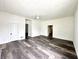 Spacious living room with ceiling fan, fresh paint, and wood-look floors, perfect for Gathering time at 106 S Hancock St, Waynetown, IN 47990