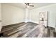 Large room with ceiling fan, fresh paint, and wood-look floors, offering flexibility for your dream design at 106 S Hancock St, Waynetown, IN 47990