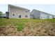 Home's backyard featuring a sloped lawn and views of neighboring houses with matching siding at 1065 Bent Branch Ln, Greenwood, IN 46143