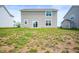 Home's backyard with a simple lawn leading up to the house with sliding glass doors and two windows at 1065 Bent Branch Ln, Greenwood, IN 46143