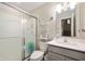 Bathroom with a glass shower, grey vanity, and a mirror over the sink, next to a shelving unit at 1065 Bent Branch Ln, Greenwood, IN 46143