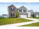 Inviting two-story home featuring a brick facade, blue shutters, and a well-maintained lawn with a sidewalk at 1065 Bent Branch Ln, Greenwood, IN 46143