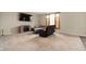 Cozy living room with plush carpet, comfortable seating, a fireplace, and a large window for natural light at 1065 Bent Branch Ln, Greenwood, IN 46143