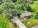 Aerial view of the house showing the landscaping, driveway, and surrounding greenery at 10854 E 700 N, Wilkinson, IN 46186