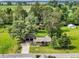 Aerial view of a property with lush greenery, a charming red barn, and surrounding countryside at 10854 E 700 N, Wilkinson, IN 46186