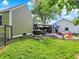 Lush backyard with a large grassy area, a covered deck, and a play area, ideal for Gathering fun and outdoor activities at 10854 E 700 N, Wilkinson, IN 46186