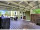 Expansive covered deck with a cozy seating area, an outdoor grill, and backyard access for seamless indoor-outdoor living at 10854 E 700 N, Wilkinson, IN 46186