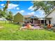Spacious backyard with a large lawn, a covered patio, and a colorful play area, perfect for outdoor enjoyment at 10854 E 700 N, Wilkinson, IN 46186