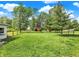 Large fenced yard with a red barn and playground, providing ample space for recreation at 10854 E 700 N, Wilkinson, IN 46186