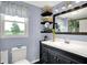 Charming bathroom with dark vanity, white sink and modern fixtures at 10854 E 700 N, Wilkinson, IN 46186