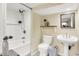 Cozy bathroom featuring a tub, shower, stylish pedestal sink, and modern fixtures with neutral colors at 10854 E 700 N, Wilkinson, IN 46186