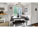 Bright dining area features built-in bench seating, a dark wood table, and modern light fixture at 10854 E 700 N, Wilkinson, IN 46186