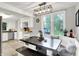 Bright dining area with a modern light fixture, built-in bench seating, and views of the backyard at 10854 E 700 N, Wilkinson, IN 46186