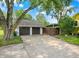Detached two-car garage with driveway and mature trees offering shade and curb appeal at 10854 E 700 N, Wilkinson, IN 46186