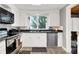 Bright kitchen with stainless steel appliances and white cabinets at 10854 E 700 N, Wilkinson, IN 46186